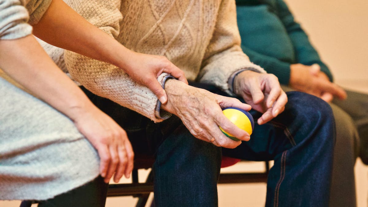 Older adults taking part in a seated mobility session